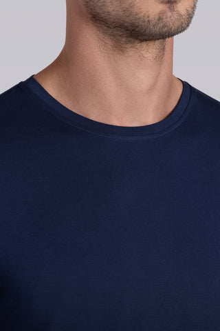 Model wearing Paramount Legion Blue long sleeve Icy Bamboo® crewneck, styled in gray pants.