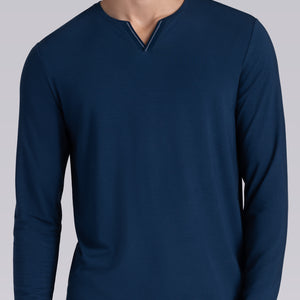 Model wearing Zen Lagoon Blue Icy Bamboo® long sleeve crewneck t-shirt, styled with grey pants.
