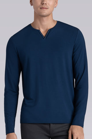 Model wearing Zen Lagoon Blue Icy Bamboo® long sleeve crewneck t-shirt, styled with grey pants.