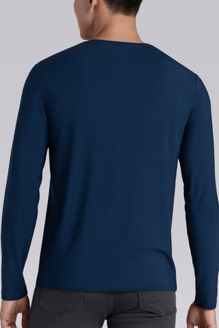 Model wearing Zen Lagoon Blue Icy Bamboo® long sleeve crewneck t-shirt, styled with grey pants.
