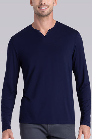 Model wearing Zen Navy Icy Bamboo® long sleeve crewneck t-shirt, styled with grey pants.