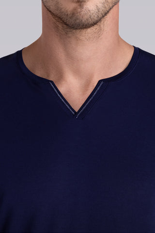 Model wearing Zen Navy Icy Bamboo® long sleeve crewneck t-shirt, styled with grey pants.