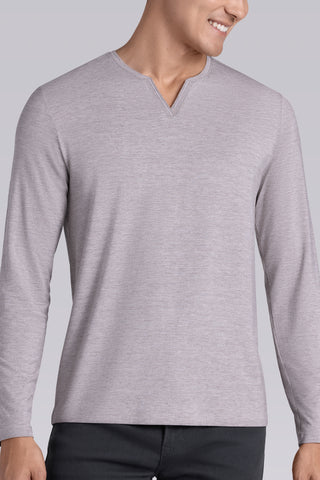 Model wearing Zen Oak Tree Heather Icy Bamboo® long sleeve crewneck t-shirt, styled with grey pants.