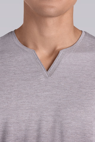 Model wearing Zen Oak Tree Heather Icy Bamboo® long sleeve crewneck t-shirt, styled with grey pants.