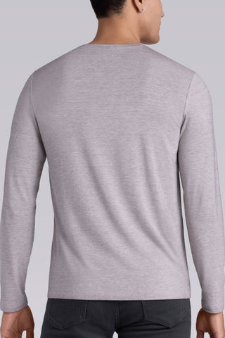 Model wearing Zen Oak Tree Heather Icy Bamboo® long sleeve crewneck t-shirt, styled with grey pants.
