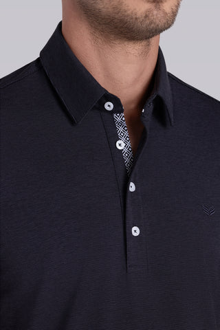 Model wearing Clubhouse Charcoal Icy Cotton® short sleeve polo, styled with light grey pants.