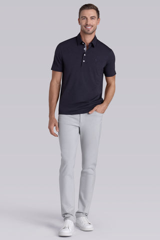Model wearing Clubhouse Charcoal Icy Cotton® short sleeve polo, styled with light grey pants.