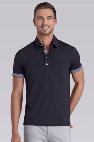 Model wearing Clubhouse Charcoal Icy Cotton® short sleeve polo, styled with light grey pants.