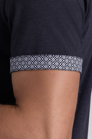 Model wearing Clubhouse Charcoal Icy Cotton® short sleeve polo, styled with light grey pants.