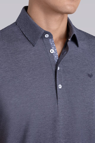 Model wearing Clubhouse Navy Icy Cotton® short sleeve polo, styled with navy pants.