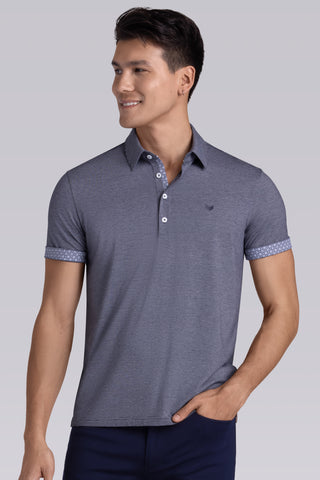 Model wearing Clubhouse Navy Icy Cotton® short sleeve polo, styled with navy pants.