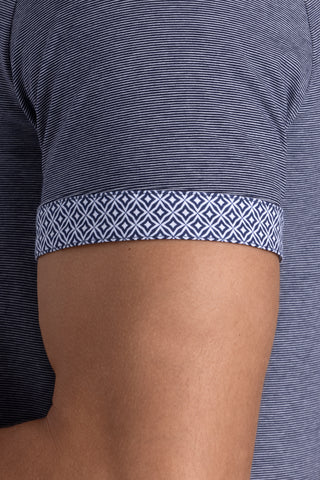 Model wearing Clubhouse Navy Icy Cotton® short sleeve polo, styled with navy pants.