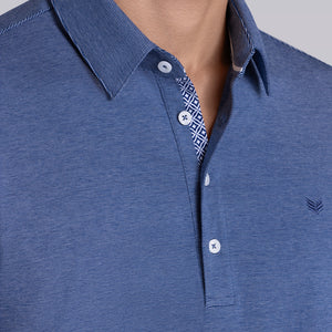 Model wearing Clubhouse Vintage Blue Icy Cotton® short sleeve polo, styled with white pants.