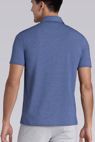 Model wearing Clubhouse Vintage Blue Icy Cotton® short sleeve polo, styled with white pants.