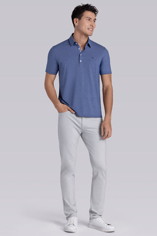 Model wearing Clubhouse Vintage Blue Icy Cotton® short sleeve polo, styled with white pants.