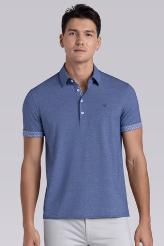 Model wearing Clubhouse Vintage Blue Icy Cotton® short sleeve polo, styled with white pants.