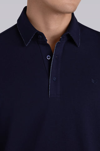 Model wearing Class Navy long sleeve Icy Cotton® Jaquard Polo, styled with light grey pants.
