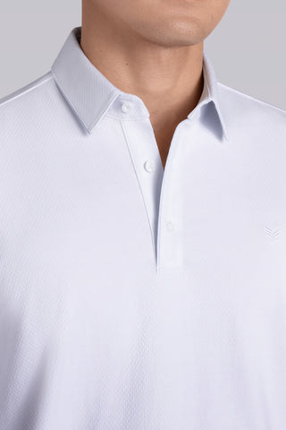 Model wearing Class White long sleeve Icy Cotton® Jaquard Polo, styled with white pants.
