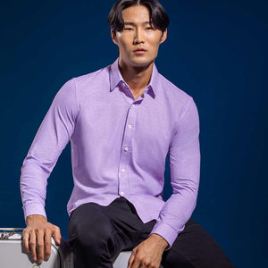 Model wearing the Elusive Purple long sleeve dress shirt, styled with fitted black dress slacks.