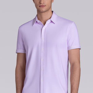 Model wearing Zest Lilac short sleeve classic collar shirt, styled with white shorts.