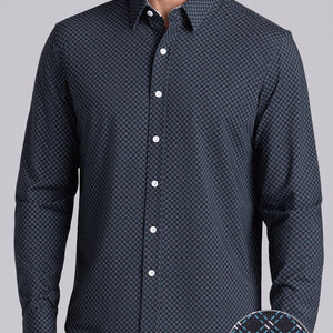 Model wearing Empower Black Green long sleeve dress shirt, styled black pants.