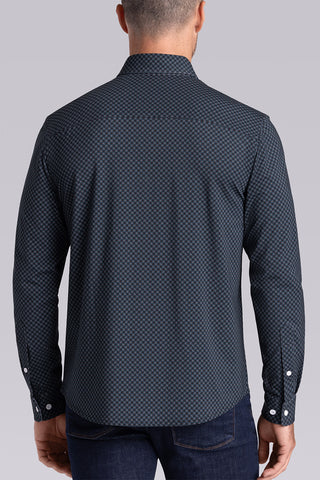 Model wearing Empower Black Green long sleeve dress shirt, styled black pants.
