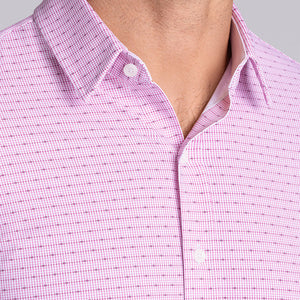 Model wearing Rhythm Raspberry Sorbet 6-Way Knit® short sleeve casual shirt with collar placket, styled with navy shorts.