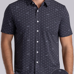 Model wearing Drift Charcoal Heather short sleeve car print shirt, styled with white shorts
