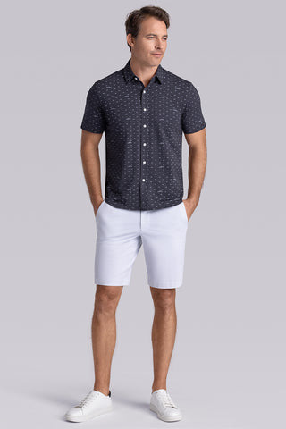 Model wearing Drift Charcoal Heather short sleeve car print shirt, styled with white shorts