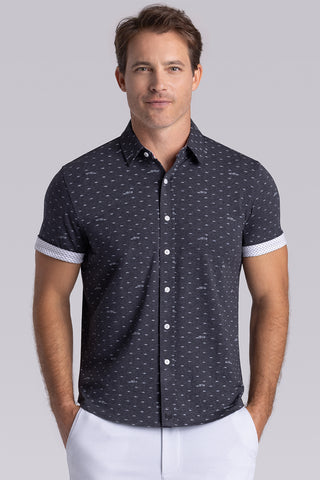 Model wearing Drift Charcoal Heather short sleeve car print shirt, styled with white shorts