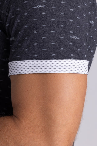 Model wearing Drift Charcoal Heather short sleeve car print shirt, styled with white shorts