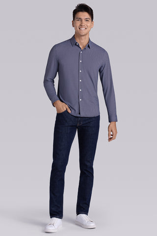 Model wearing Spry Navy Taupe long sleeve shirt with built in classic collar with geometric print, styled with jeans pants.