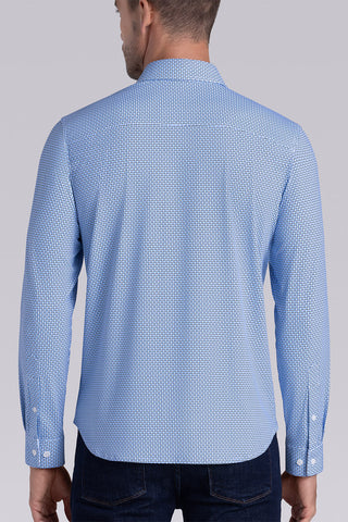 Model wearing Spry Ocean Blue long sleeve shirt with built in classic collar with geometric print, styled with jeans pants.
