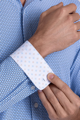Model wearing Spry Ocean Blue long sleeve shirt with built in classic collar with geometric print, styled with jeans pants.