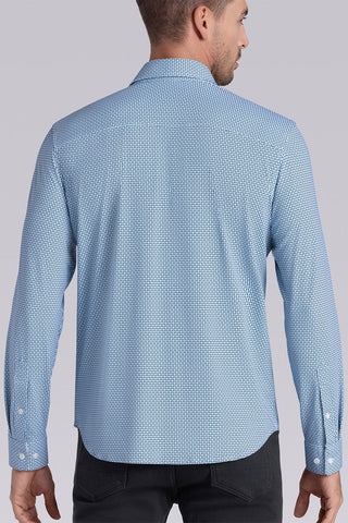 Model wearing Spry Seafoam long sleeve shirt with built in classic collar with geometric print, styled with jeans pants.