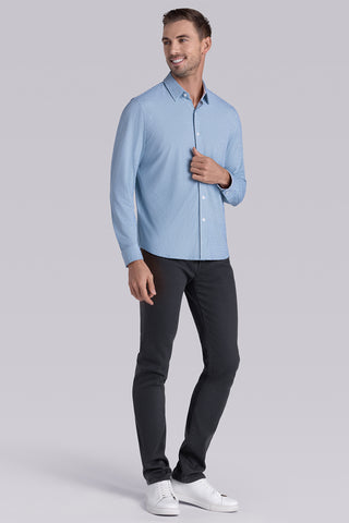 Model wearing Spry Seafoam long sleeve shirt with built in classic collar with geometric print, styled with jeans pants.