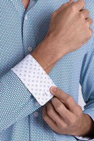 Model wearing Spry Seafoam long sleeve shirt with built in classic collar with geometric print, styled with jeans pants.