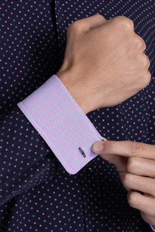Model wearing Committed Navy Pink long sleeve shirt with built in classic collar with geometric print, styled with jeans.
