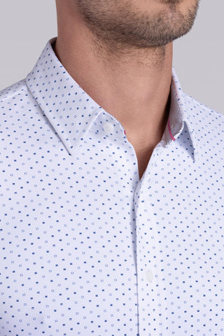 Model wearing Committed White Navy long sleeve shirt with built in classic collar with geometric print, styled with jeans.