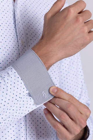 Model wearing Committed White Navy long sleeve shirt with built in classic collar with geometric print, styled with jeans.