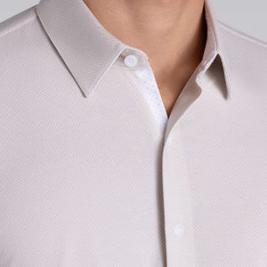 Model wearing Strive Light Taupe Icy Cotton® long sleeve shirt with classic collar and french placket, styled with black pants