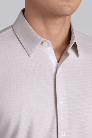 Model wearing Strive Light Taupe Icy Cotton® long sleeve shirt with classic collar and french placket, styled with black pants