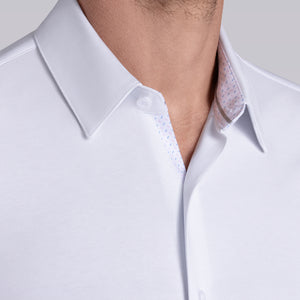 Model wearing Strive White Icy Cotton® long sleeve shirt with classic collar and french placket, styled with khaki pants