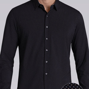 Model wearing Ignite Black Icy Cotton® long sleeve shirt with classic collar and placket, styled with navy pants