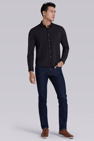 Model wearing Ignite Black Icy Cotton® long sleeve shirt with classic collar and placket, styled with navy pants