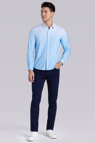 Model wearing Flex Light Blue Icy Cotton® long sleeve shirt with classic collar and french placket, styled with black pants.