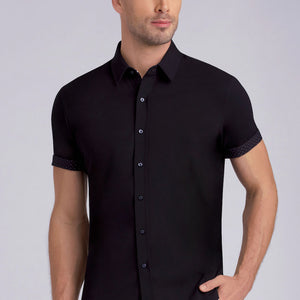 Model wearing Monumental Black short sleeve collar shirt, styled with white pants.