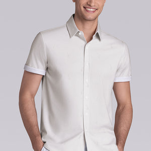 Model wear Intrepid Light Beige short sleeve print shirt, styled with white shorts.