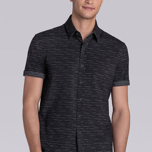Model wearing Radar Black short sleeve casual shirt with collar, styled with navy pants.
